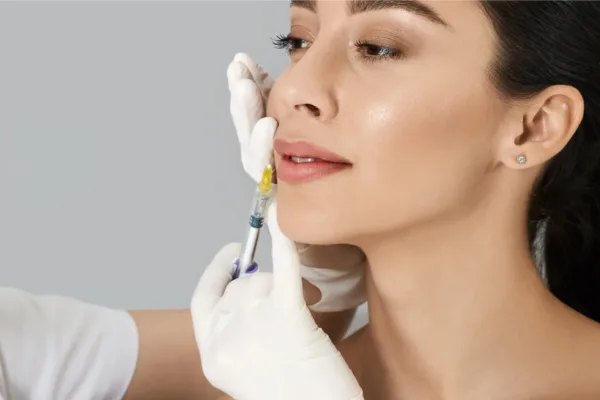 Woman modeling with needle near lip