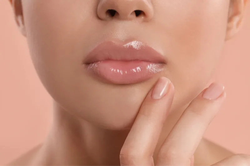 Featured Image Close up of woman's face with shiny lips